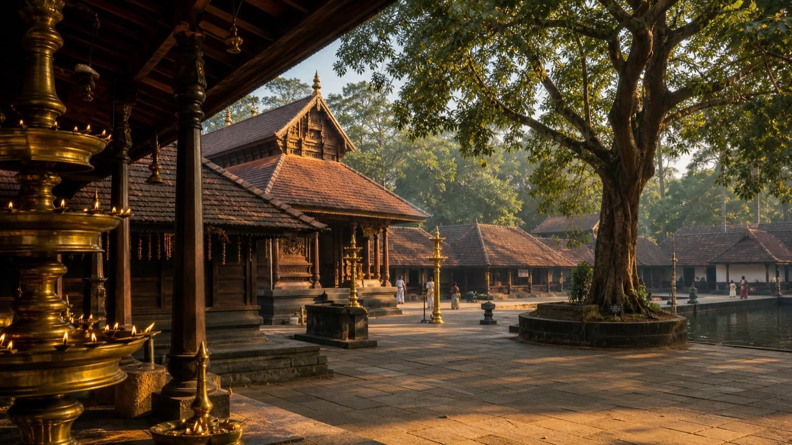 Traditional Kerala temple courtyard with brass lamps and tiled roofs